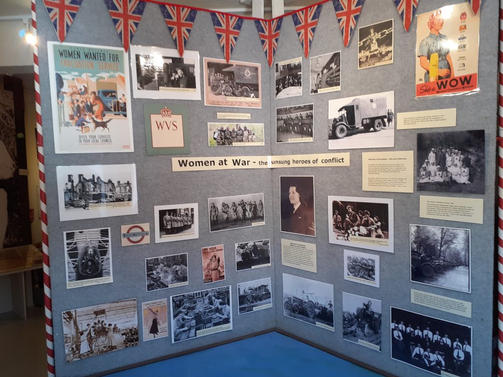 Display of photos and posters showing women in wartime