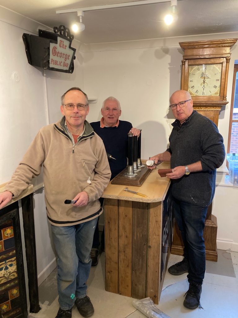 Volunteers from Avon Valley Shed by relocated bar in Fordingbridge Museum
