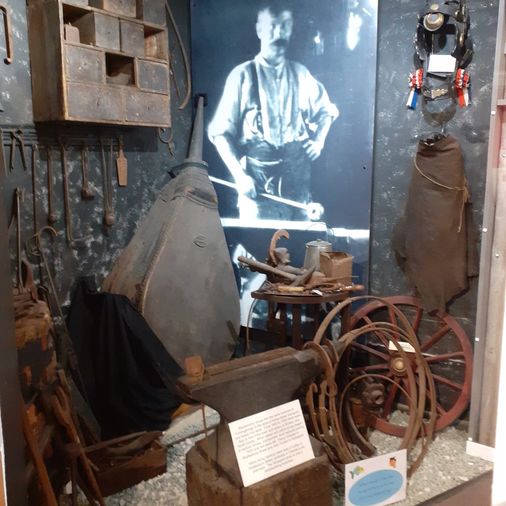 Display of blacksmith's forge with anvil and large bellows