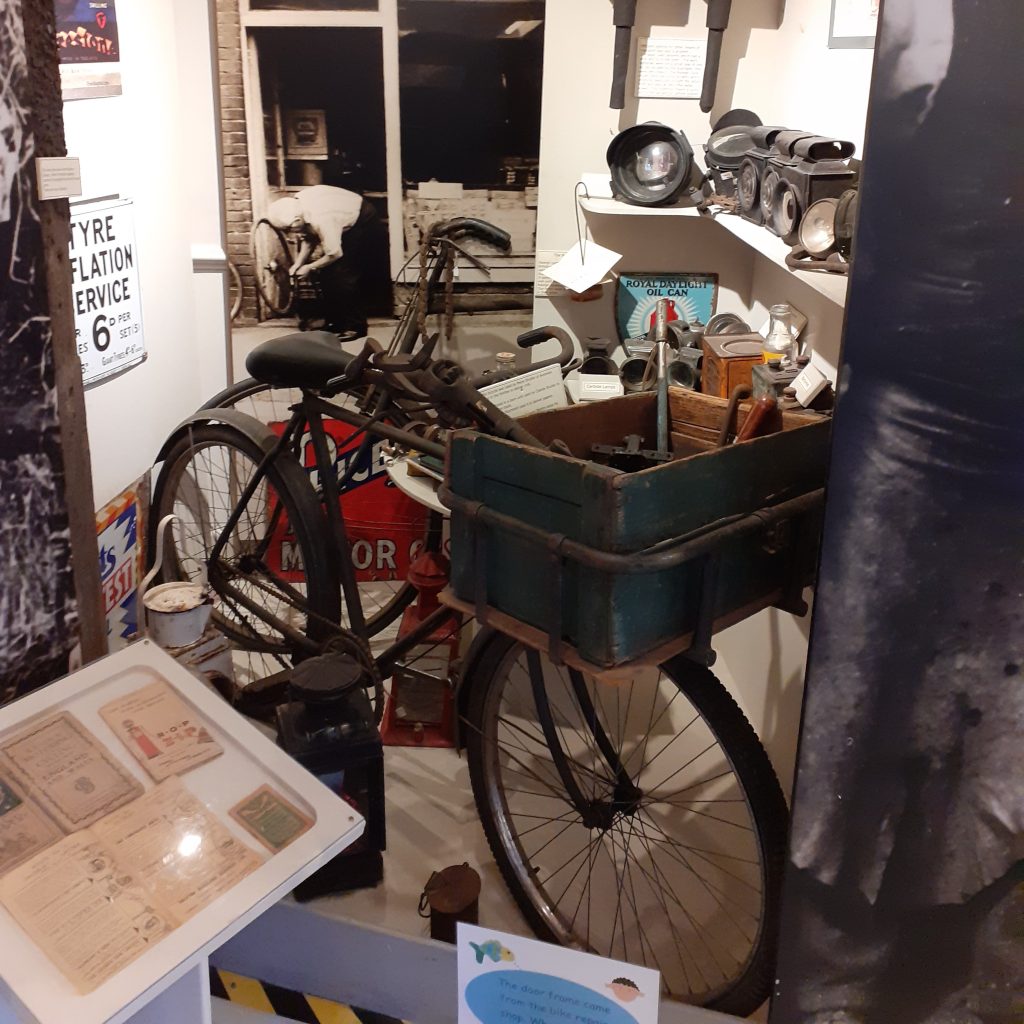 Cycle shop display showing vintage bike with wicker basket on the front