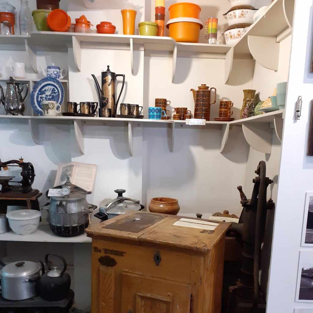 Old household equipment including an ice box, Tupperware and Pyrex.