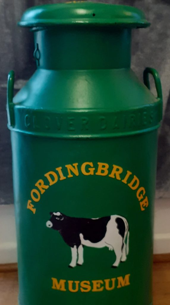 Green milk churn for donations.