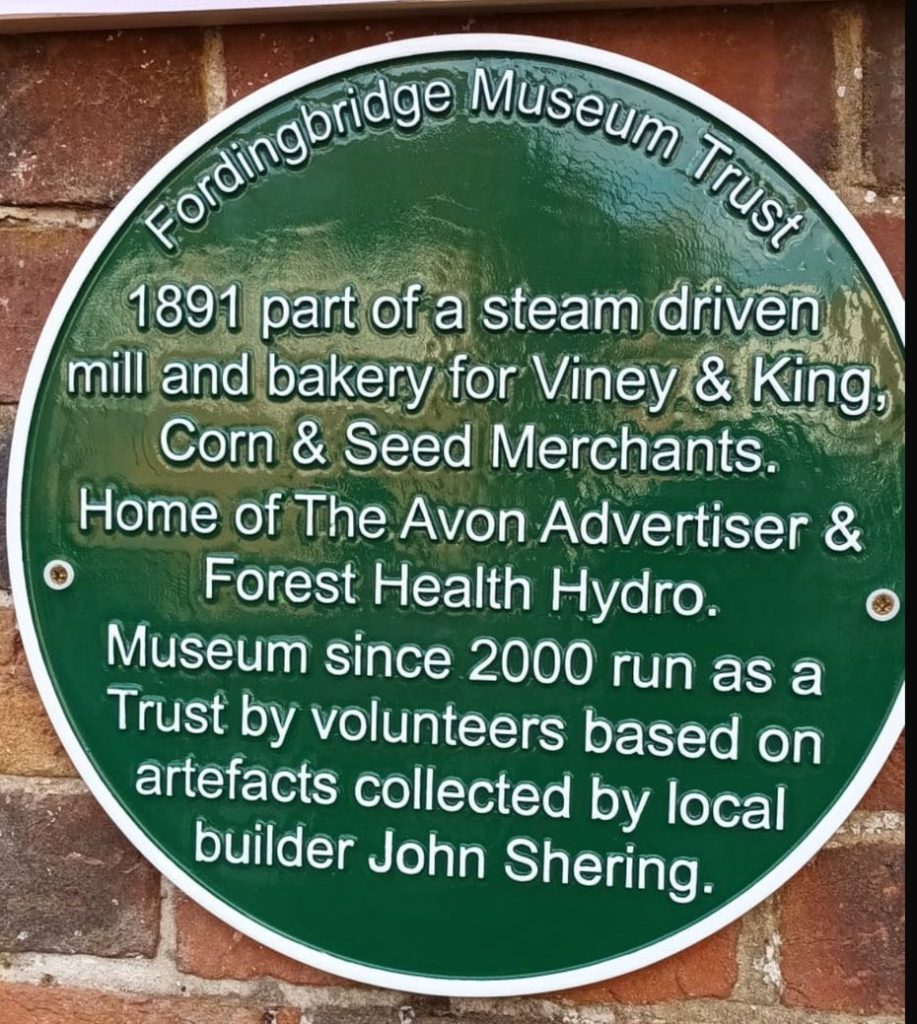 Green plaque explaining history of Fordingbridge Museum's building
